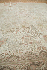 Distressed Tabriz carpet detail: intricate Kerman vase motif, blush, ivory tones, and visible foundation.