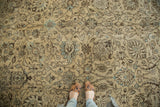 Detail of distressed Tabriz with faded beige, brown, and sky blue floral vinery.
