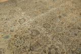 Distressed beige Tabriz carpet field with brown palmettes, lotus flowers, and scrolling vinery.