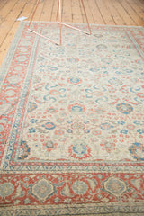 Distressed ivory field with soft floral and palmette patterns, and a pomegranate red border.
