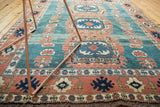 Abrashed blue-green field and terra cotta splayed floral main border on a vintage Turkish Oushak rug.