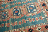 Terra cotta splayed floral border and abrashed ocean green field of vintage Oushak rug.