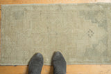 Textural close-up of the hand-knotted vintage Oushak runner with subtle ivory and beige geometric patterns.