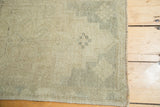 Subtle ivory and silver geometric drawing on hand-knotted pile with secured side.