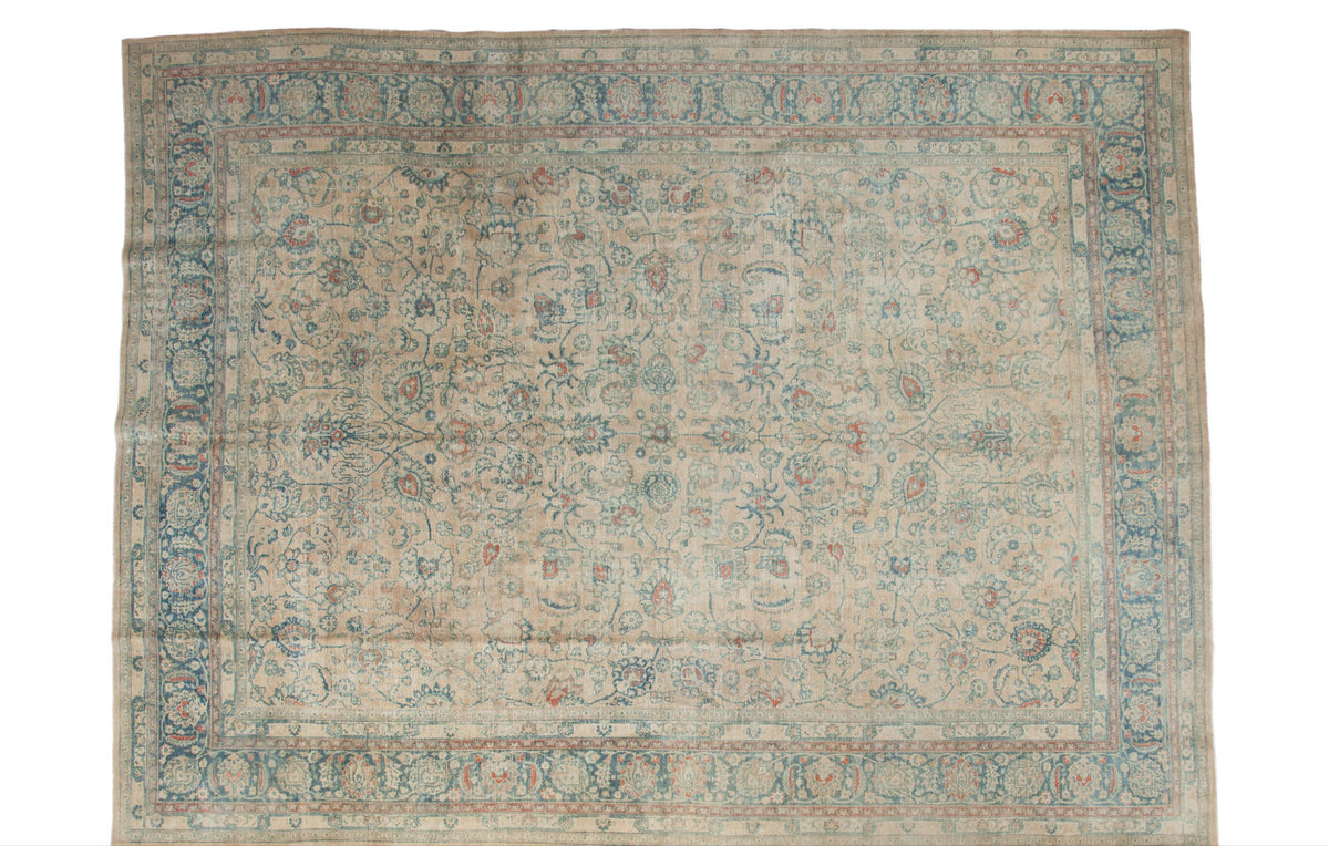 Vintage Distressed Persian Meshed carpet, faded beige, ink blue, and apricot scrolling vinery.
