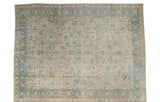 Vintage Distressed Persian Meshed carpet, faded beige, ink blue, and apricot scrolling vinery.