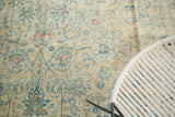 Distressed vintage Persian Meshed carpet, ink blue scrolling vinery, and apricot lotus motifs.