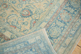 Folded vintage Meshed carpet revealing distressed beige, blue lotus vinery pile and hand-knotted blue foundation.