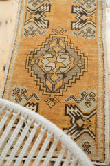 Tangerine orange vintage Oushak runner with ivory germinating plant motif and stepped medallion.