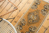 Vintage Oushak rug corner with tangerine orange field and ivory, charcoal plant motifs.