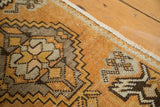Tangerine orange vintage Oushak rug with geometric plant motif and secured side.