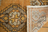 Vintage Oushak rug showing tangerine orange pile, stepped medallion, hand-knotted back, and fringe.