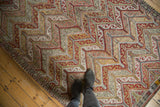 Vintage Turkish Jijim rug texture, highlighting blanched blush, gold, charcoal zig-zag patterns underfoot.