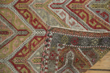 Folded corner of vintage Jijim rug, revealing geometric zig-zag flatweave and woven reverse.