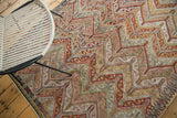 Detail of vintage Jijim rug's blanched blush, ivory, gold, charcoal, tangerine zig-zag pattern.