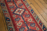 Vintage Dosmealti rug runner with barber pole border, cherry red field and sky blue, ivory, oxidized green florals.