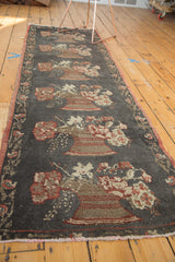 Vintage Oushak runner's repeating European floral bouquets on charcoal field.