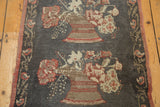Charcoal Oushak runner with a floral planter motif and a blossoming vine border in wine red and ivory.