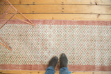 Distressed Oushak runner with textured blush quatrefoil diamonds on an ivory lattice.