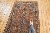 Antique Persian Qashqai runner detail: herati motif and medallion, chestnut brown and sky blue.