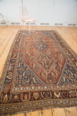 Antique Persian Qashqai runner displays triple medallion Herati motif in chestnut, sky blue, charcoal, saffron.