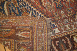 Secured edge of an antique Qashqai rug, revealing hand-knotted construction and distressed fringe.