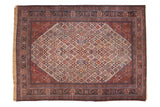 Distressed vintage Joshegan carpet with allover symbolic field and brick red borders, 8'3