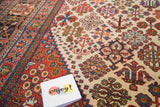 Vintage distressed Joshegan carpet showcasing fine weave and colorful garden motifs.