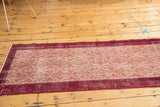 Distressed wine red border and Moroccan tile motif in pale cochineal red and ivory.