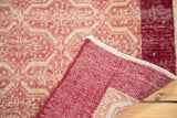 Folded vintage Konya runner showcasing distressed Moroccan tile pattern and wine red reverse.
