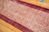Distressed vintage Konya runner showing textured pile, wine red border, and Moroccan tile motif.