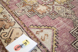 Vintage distressed Oushak rug runner with blanched eggplant purple and gold shades.