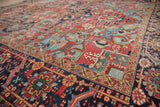 Distressed navy border and light blue stepped spandrel on antique Heriz rug corner.
