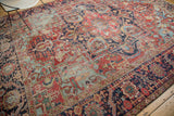 Geometric navy border framing a distressed cherry red field of an antique Heriz rug.