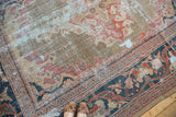 Distressed field of antique Mahal carpet showcasing brick red, navy, and rare green teal.