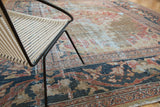 Decoratively distressed antique Mahal carpet with faded gold, navy, and terra cotta patterns.
