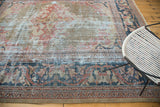 Hard distressed texture on the navy border and faded gold, red field of an antique Mahal rug.