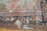 Hard distress and European floral motifs on antique Mahal border in navy, gold, terra cotta.