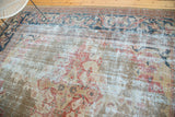 Antique Mahal carpet with distressed texture and faded red, gold patterns.