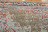 Textured historic wear on distressed antique Mahal carpet, with muted terracotta and teal.