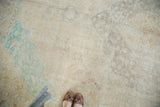 Distressed Sivas carpet textured pile with blanched mint green, pale sand, and faint vinery patterns.