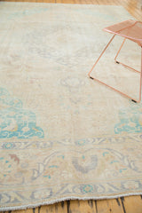 Distressed Sivas carpet corner showing blanched mint green spandrel, faded vinery, and fringe.
