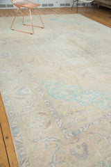 Distressed Turkish Sivas carpet showing blanched mint green vinery and pale sand field.