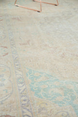 Distressed vintage Sivas carpet texture with faded mint green and saffron yellow spandrels.