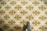 Bold saffron gold and blush floral quatrefoil lattice on ivory vintage Oushak carpet.