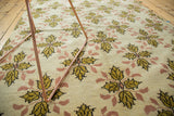 Hand-knotted Oushak rug showcasing saffron gold and blush quatrefoil floral motifs.