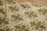 Vintage Oushak rug close-up: saffron gold floral bouquets with blush connecting elements.