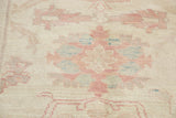 Ivory hand-knotted rug pile featuring pastel pink and seafoam green floral vinery.