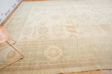 Pakistani Sultanabad rug corner, featuring pastel floral vinery and abrash details.