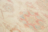 Pastel ivory, seafoam, and terracotta oversized floral motifs on hand-knotted Sultanabad pile.